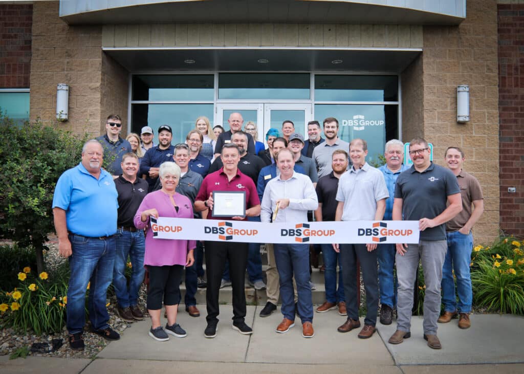 The design-build team at DBS Group post for a photo as they prepare to cut the ribbon on their new, expanded Rochester office.