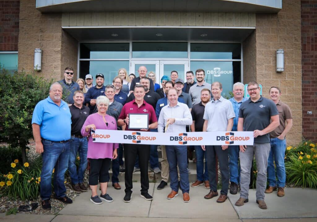The design-build team at DBS Group post for a photo as they prepare to cut the ribbon on their new, expanded Rochester office.